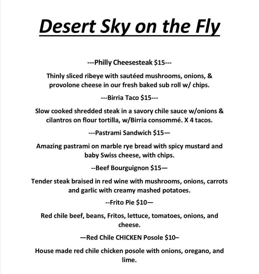 A printed Desert Sky on the Fly menu listing Philly cheesesteak, birria tacos, pastrami sandwich, beef bourguignon, frito pie and red chile chicken posole.